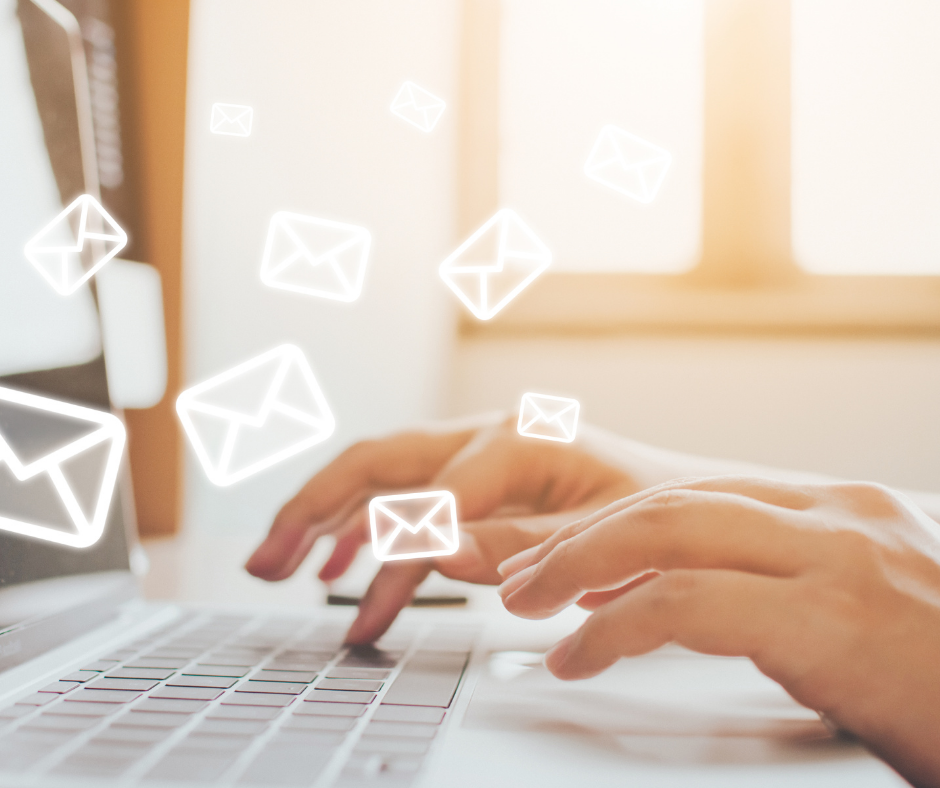 hands typing on a laptop keyboard with graphics of white envelopes in the air. This makes you think they are sending an email.